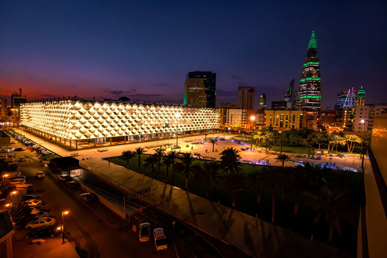 A vibrant nighttime cityscape featuring King Fahd National Library in Riyadh, Saudi Arabia.