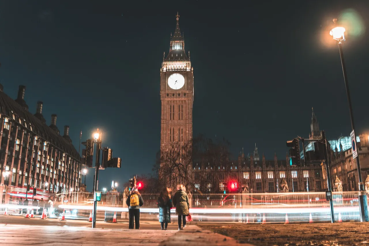 Captivating night scene of Big Ben and Westminster Palace, showcasing light trails in London.