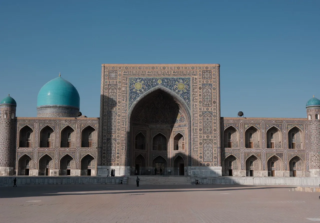 Capture of the historic Registan Mosque in Samarkand, Uzbekistan under a clear blue sky.